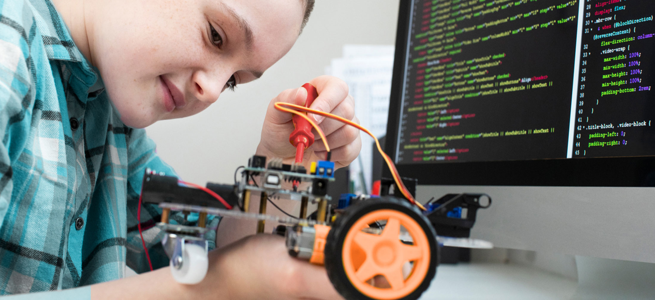 Middle Age school girl works on a robotics project.