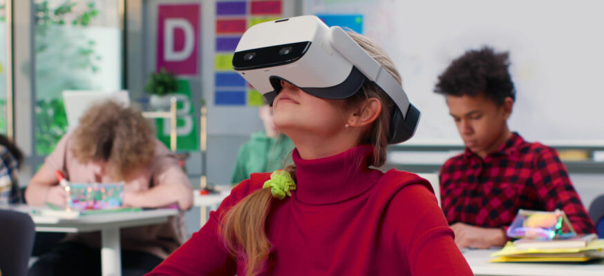 young girl in class looking through a VR headset