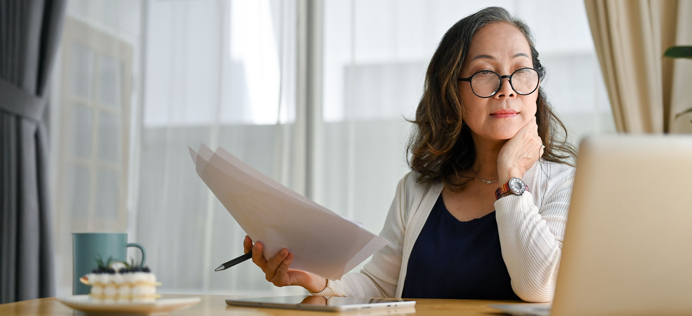 Woman looking at her Laptop trying to make a decision