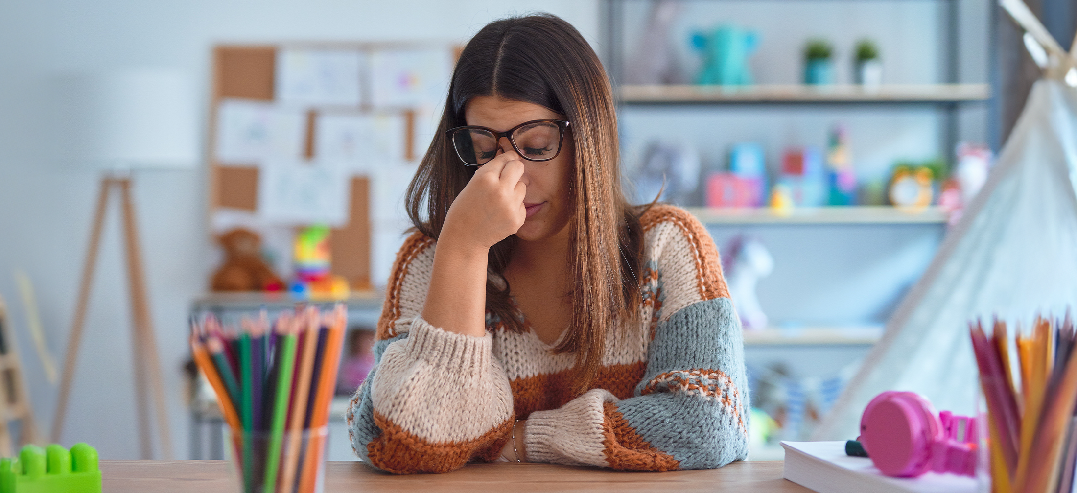 Teacher rubbing the bridge of her nose