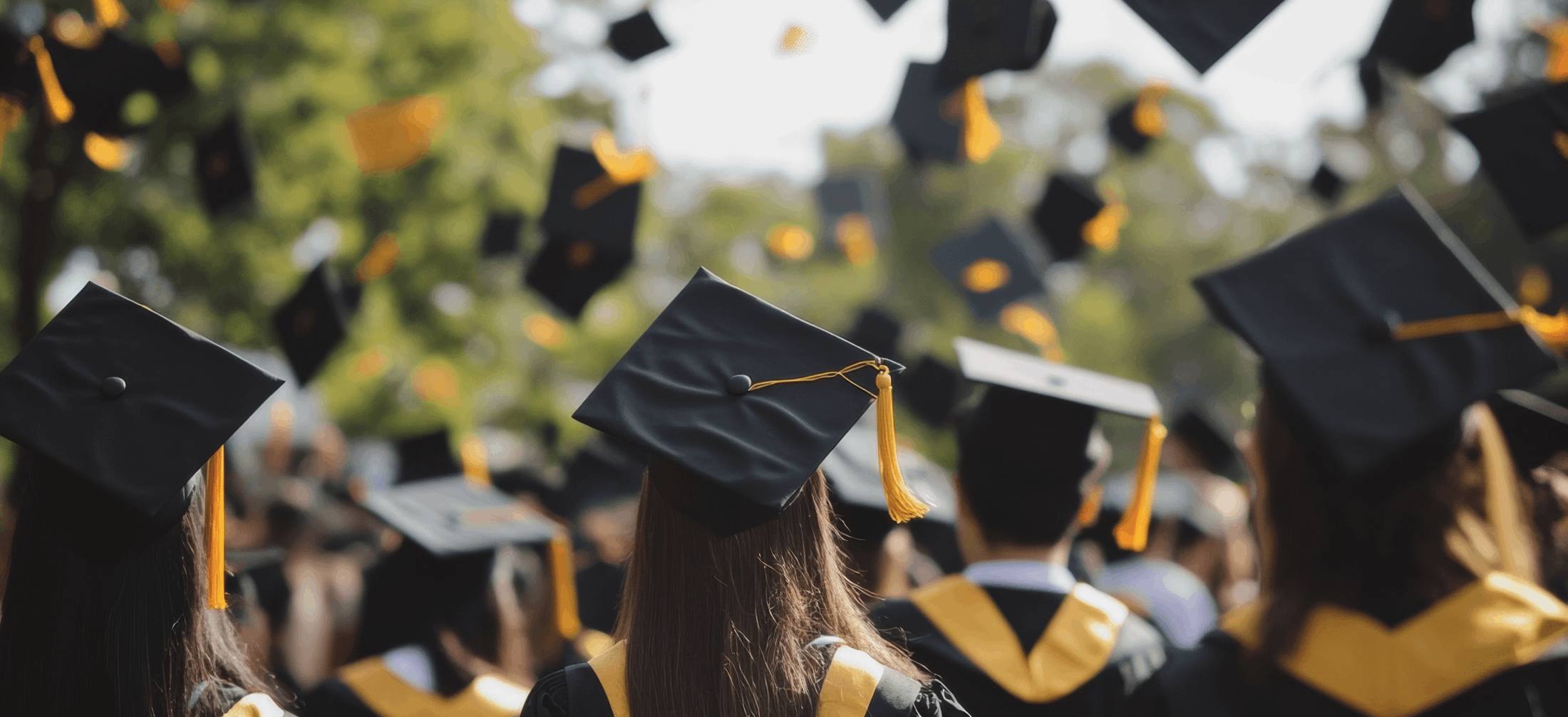 graduates tossing caps