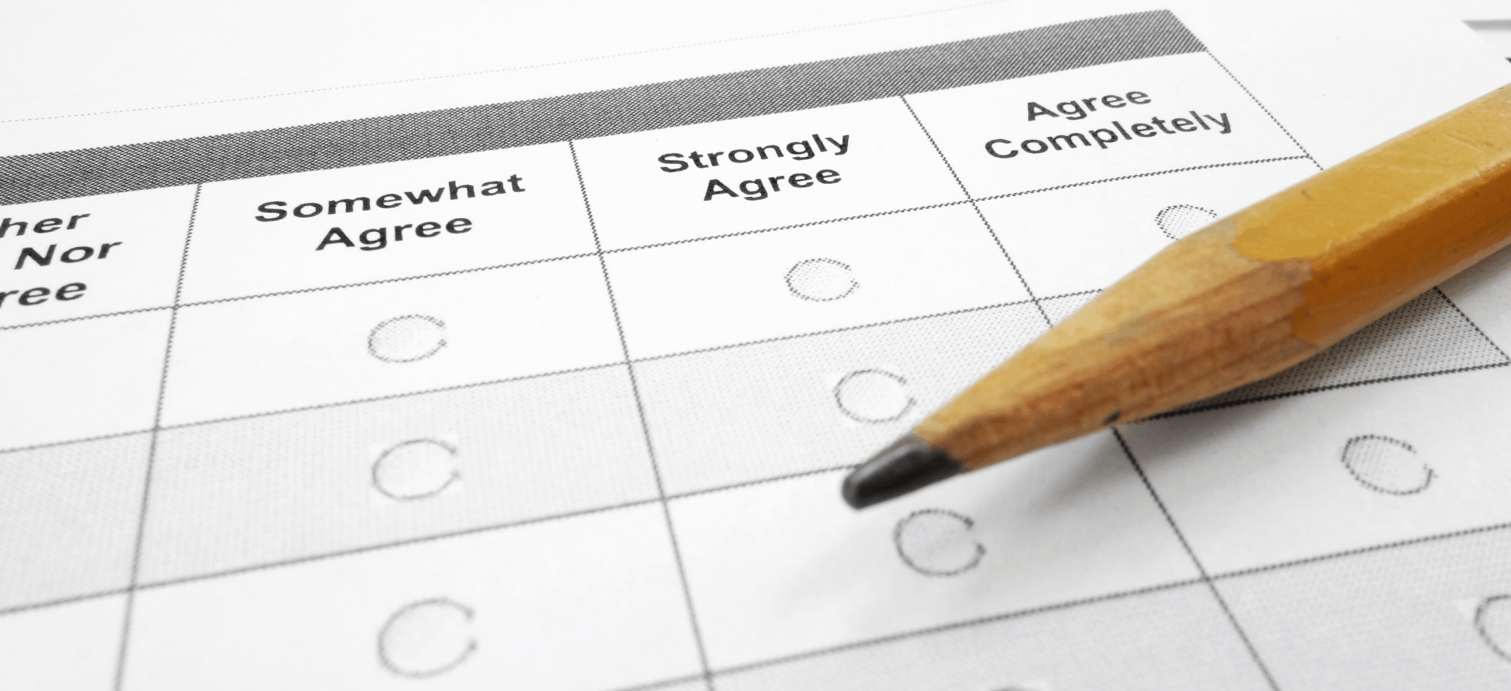 closeup of pencil with survey showing options for somewhat agree, strongly agree, and agree completely